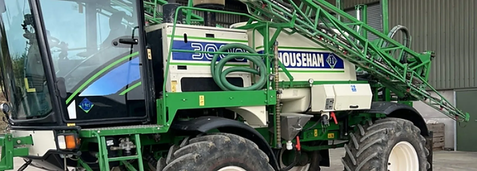 Self-propelled sprayer in the yard with the boom folded